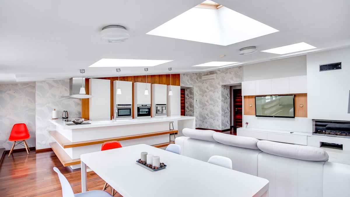 Bright and contemporary apartment space with kitchen island and living area.
